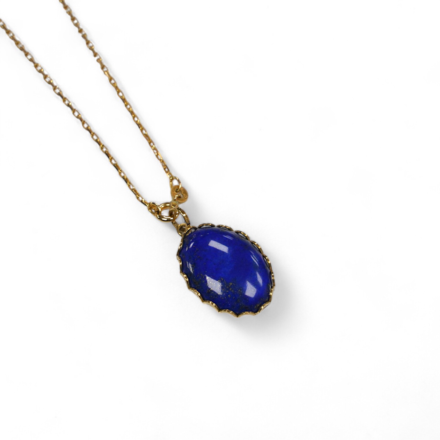 A modern 9ct gold mounted oval lapis lazuli pendant, 25mm, on a 9k fine link chain, 36cm, gross weight 8.2 grams. Condition - fair to good